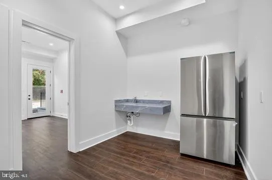 a bathroom with a granite countertop toilet a sink and mirror