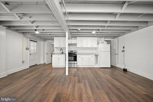 a view of a kitchen with wooden floor and a kitchen