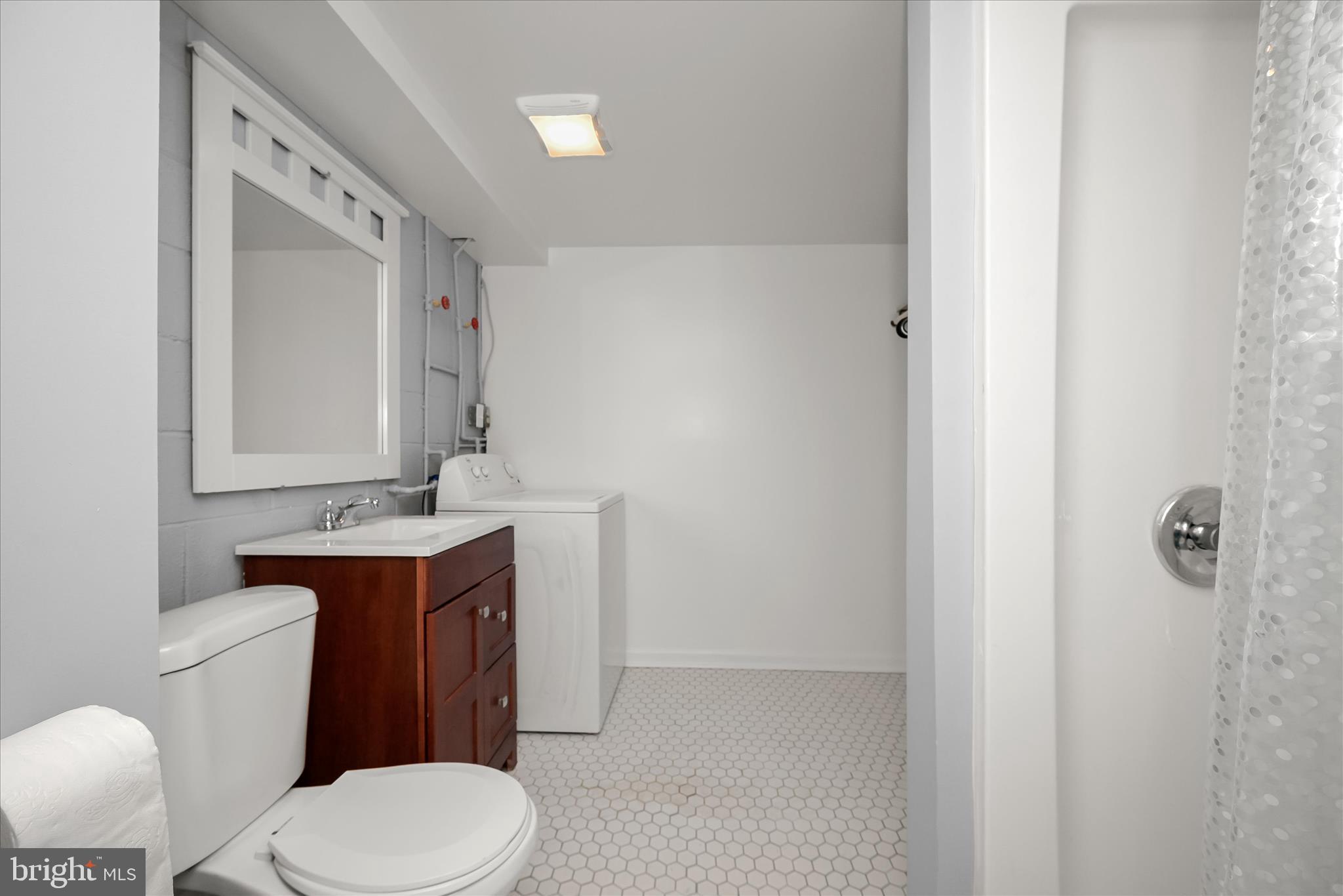 1639 The Strand Westminster, MD 21157 - Photo 16 of 18 a bathroom with a toilet a sink a vanity and mirror