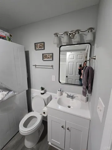a view of a bedroom with furniture and wooden floor