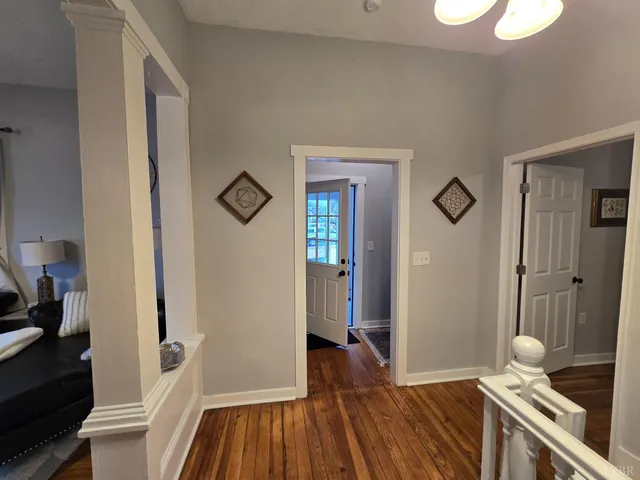 a dining room with furniture and wooden floor