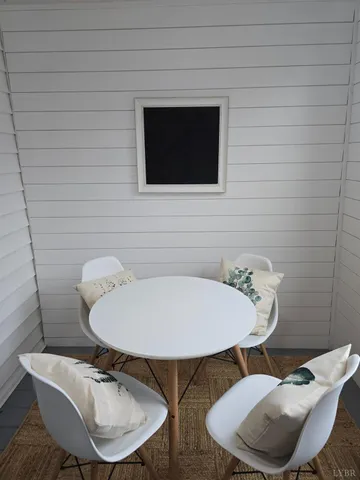 a bedroom with a bed and painting on the wall