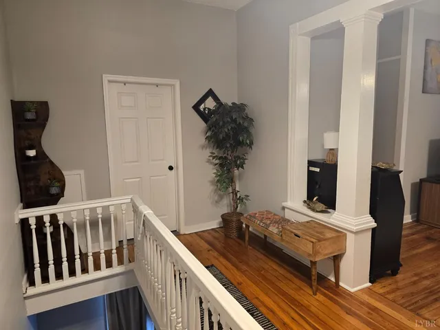 a dining room with furniture and wooden floor
