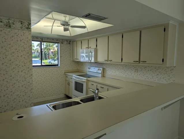 a kitchen with a sink cabinets and window