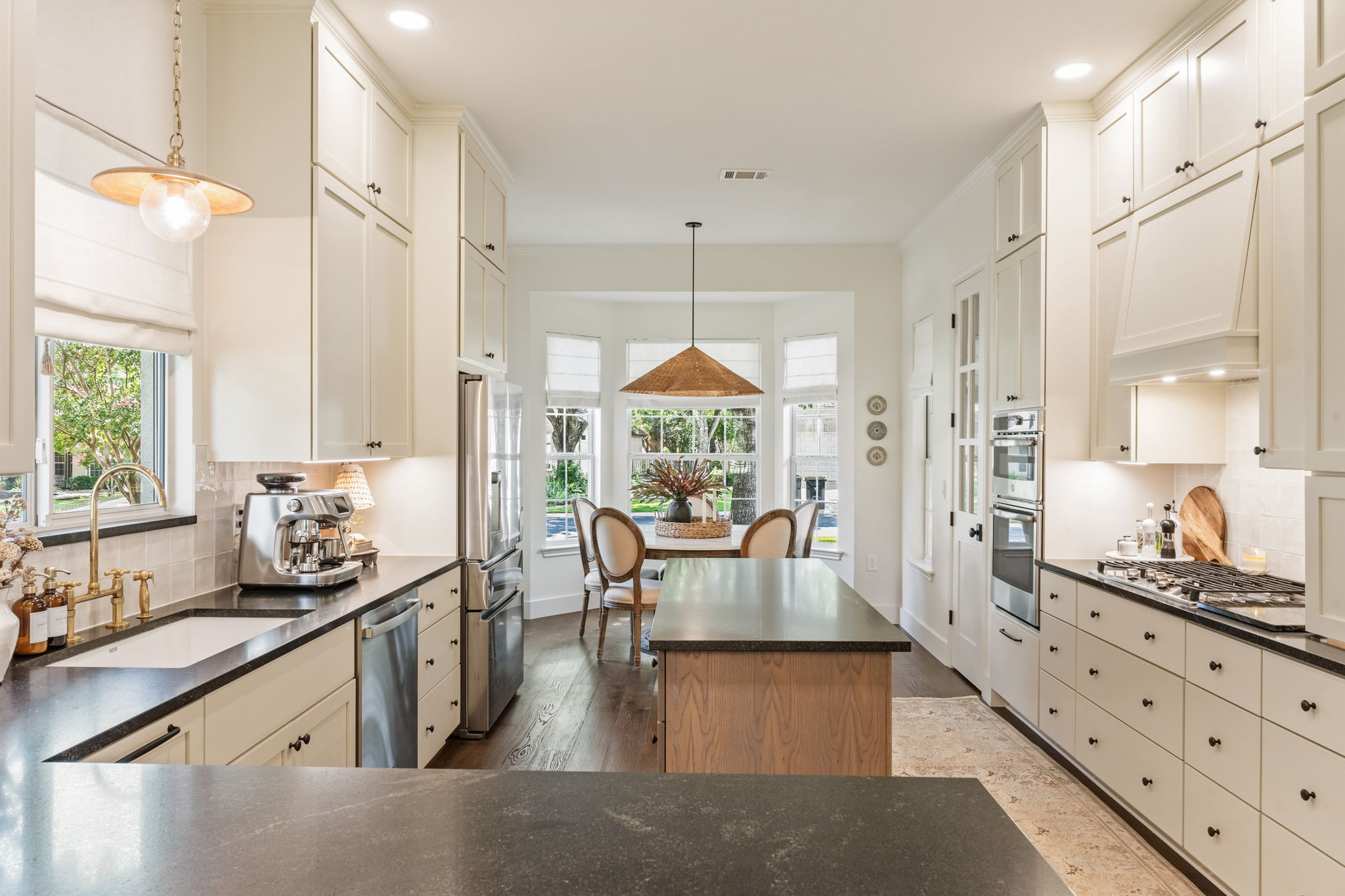 118 Cold Springs Drive Georgetown, TX 78633 - Photo 14 of 40 An inviting kitchen features a central island, rich dark flooring, and ample cabinetry, culminating in a charming breakfast nook.