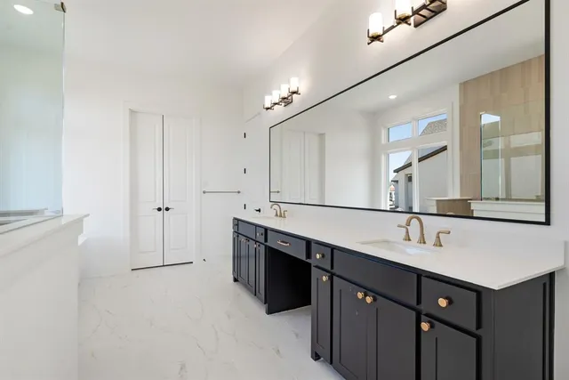 a bathroom with a double vanity sink and mirror