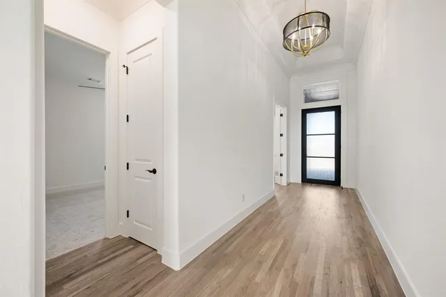 a view of a room with wooden floor