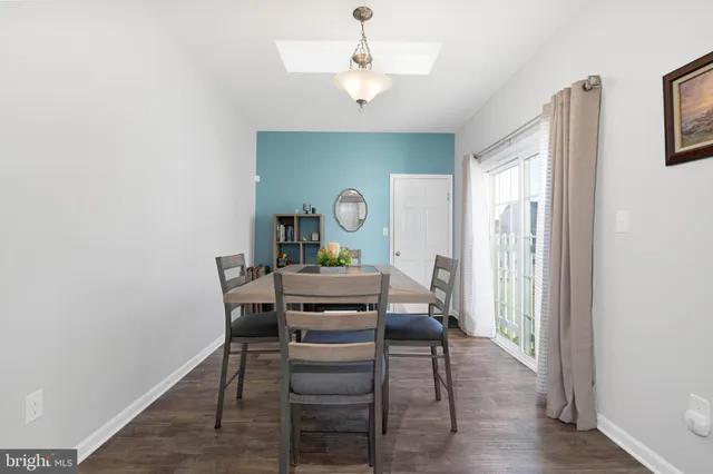 a view of a workspace with furniture and wooden floor