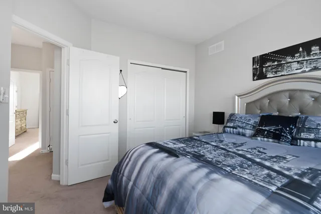 a bedroom with a bed a table and chair