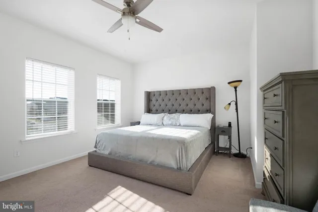 a bedroom with a bed closet and window