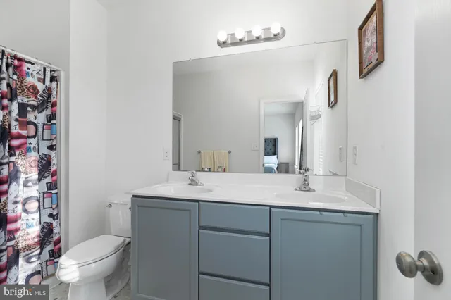a bathroom with a sink toilet and mirror