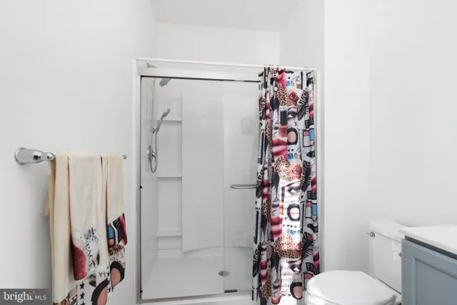 a bathroom with a shower toilet and a shower curtain