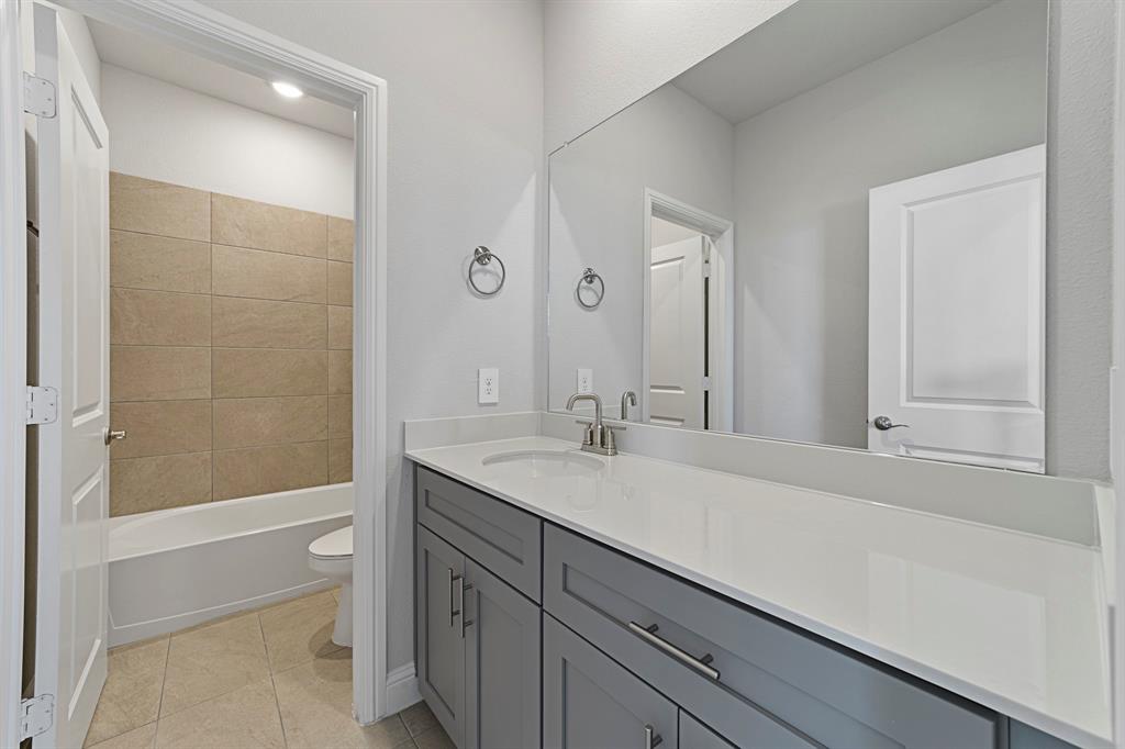 11231 Chimes Street Frisco, TX 75035 - Photo 4 of 5 a bathroom with a sink a toilet and shower