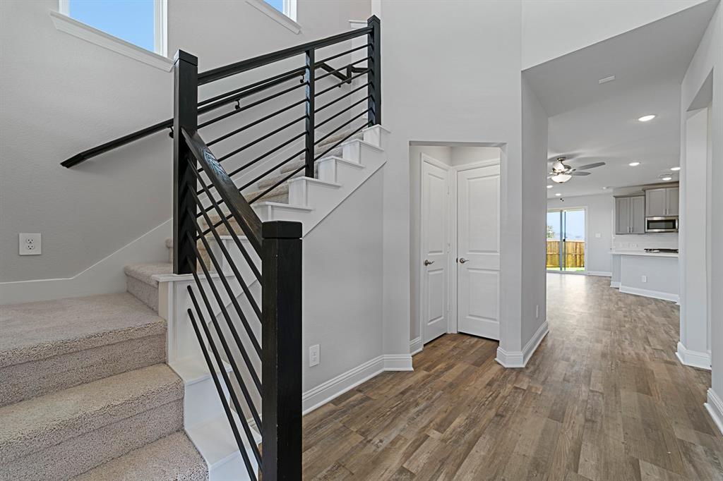 11231 Chimes Street Frisco, TX 75035 - Photo 5 of 5 a view of a hallway with wooden floor and staircase