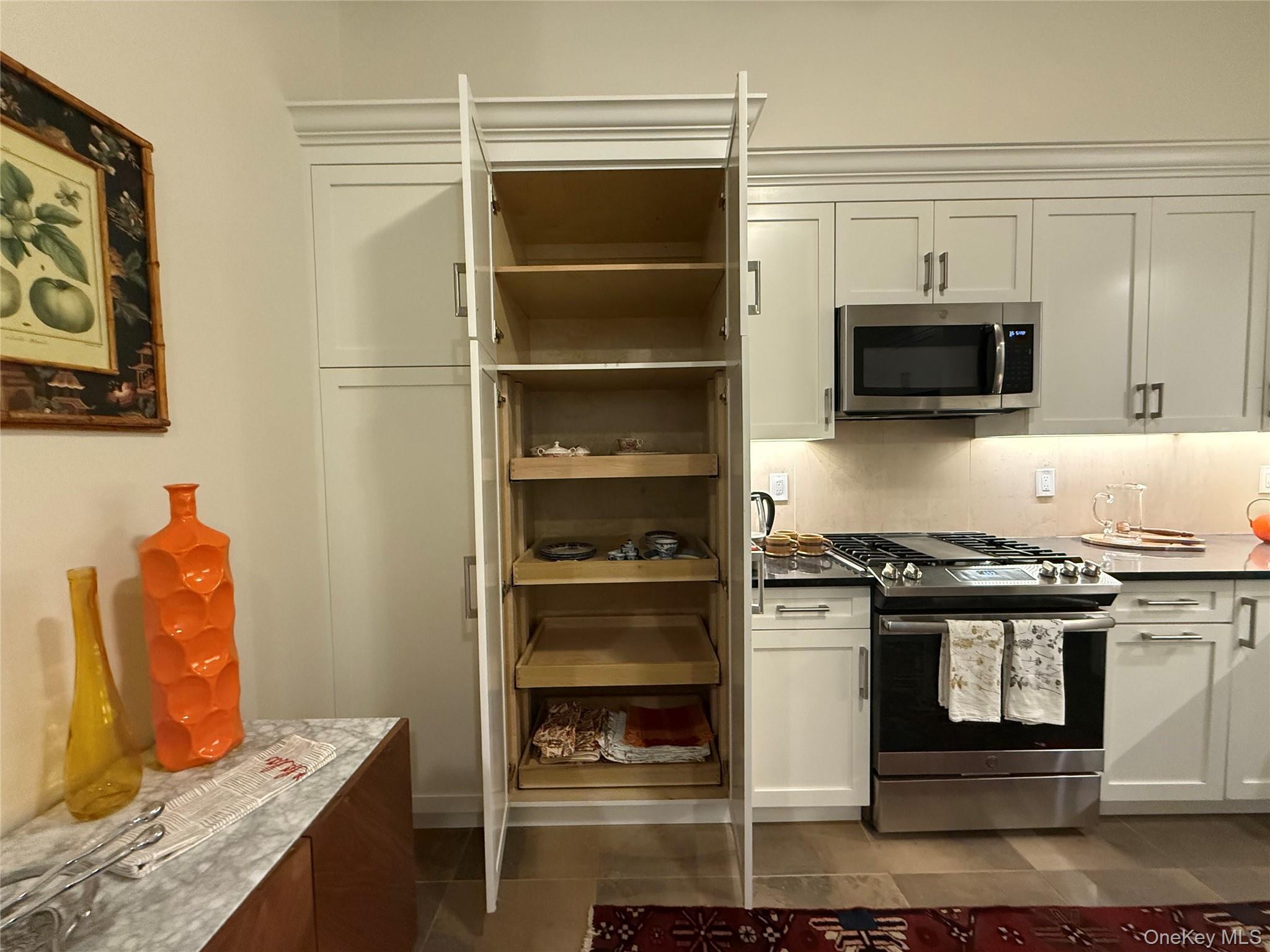 125 Main Street, Unit 2A Ossining, NY 10562 - Photo 20 of 23 a kitchen with stainless steel appliances granite countertop a stove and a microwave
