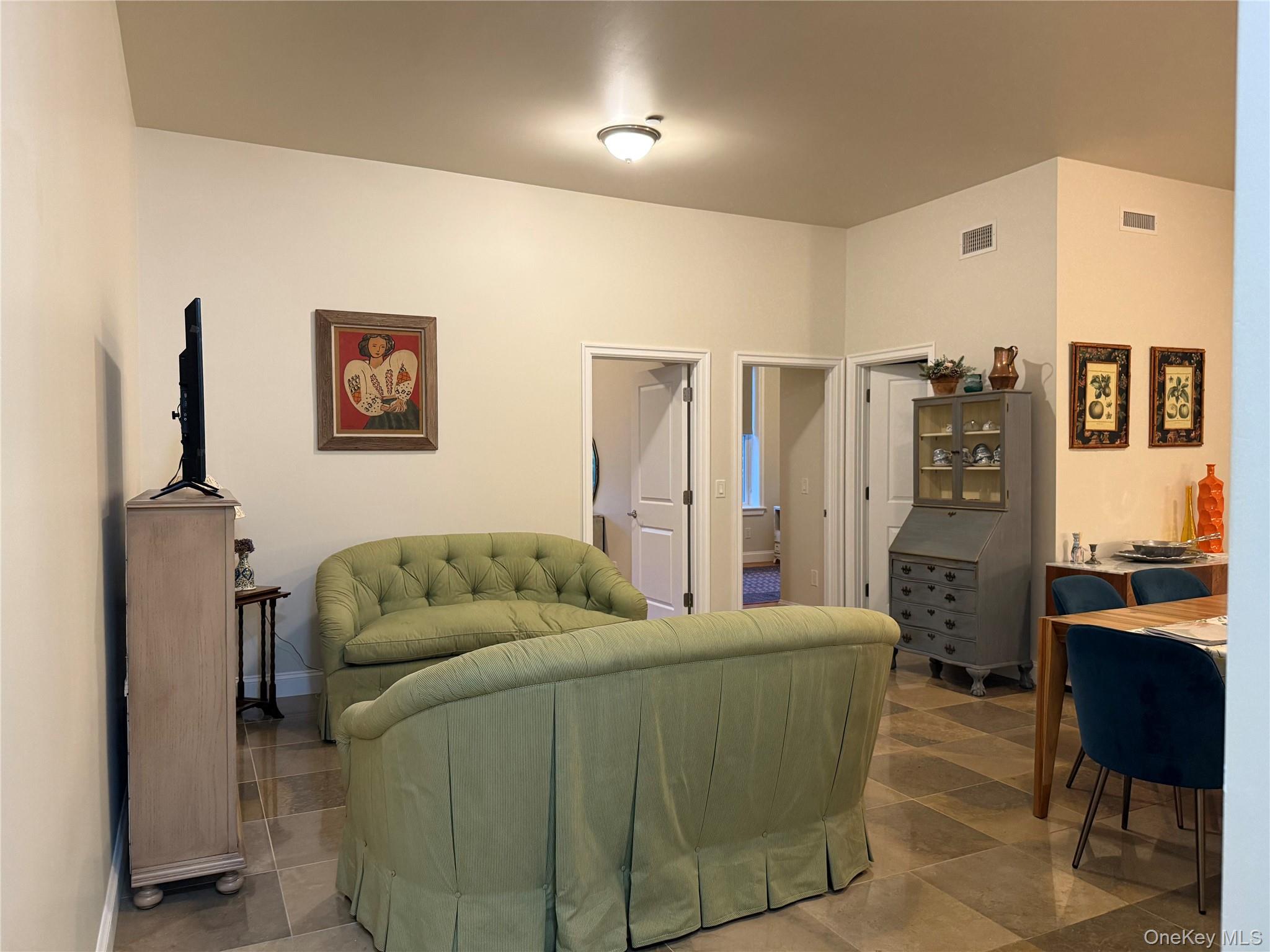 125 Main Street, Unit 2A Ossining, NY 10562 - Photo 6 of 23 a living room with furniture and a flat screen tv