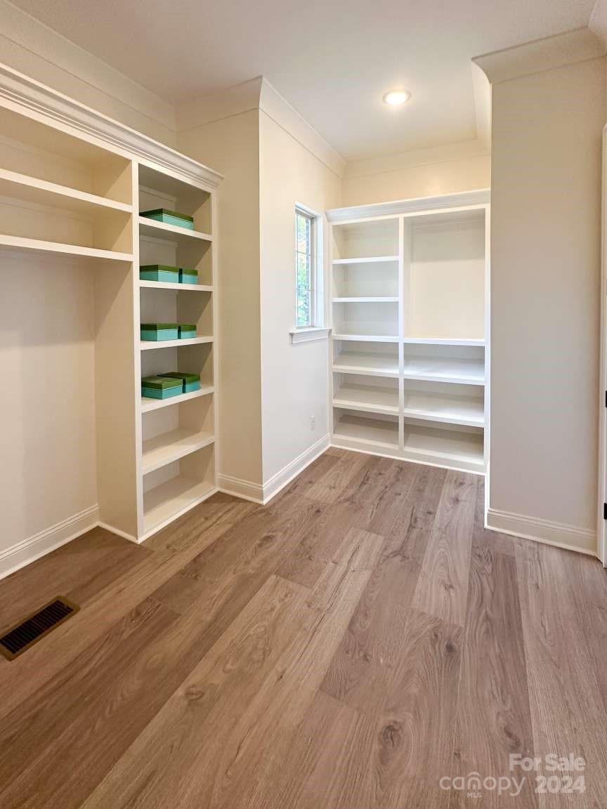 8316 Rolling Fields Road Charlotte, NC 28227 - Photo 27 of 35 a view of an empty room with a window and wooden floor