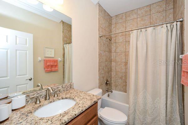 4212 Expedition Way Osprey, FL 34229 - Photo 21 of 28 a bathroom with a granite countertop sink toilet and shower