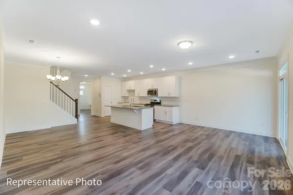 a view of kitchen with kitchen island and stainless steel appliances