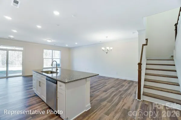 a kitchen with sink cabinets and wooden floor