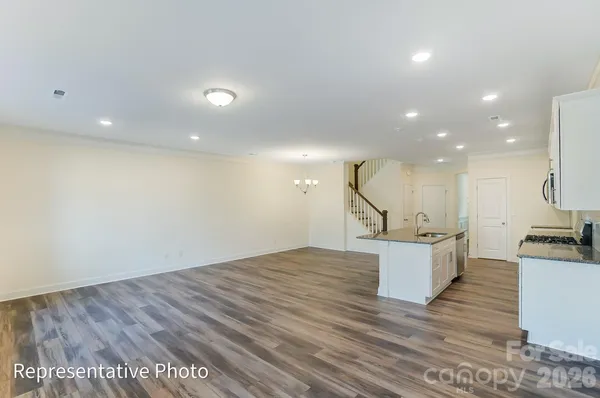 a view of kitchen and hall with wooden floor