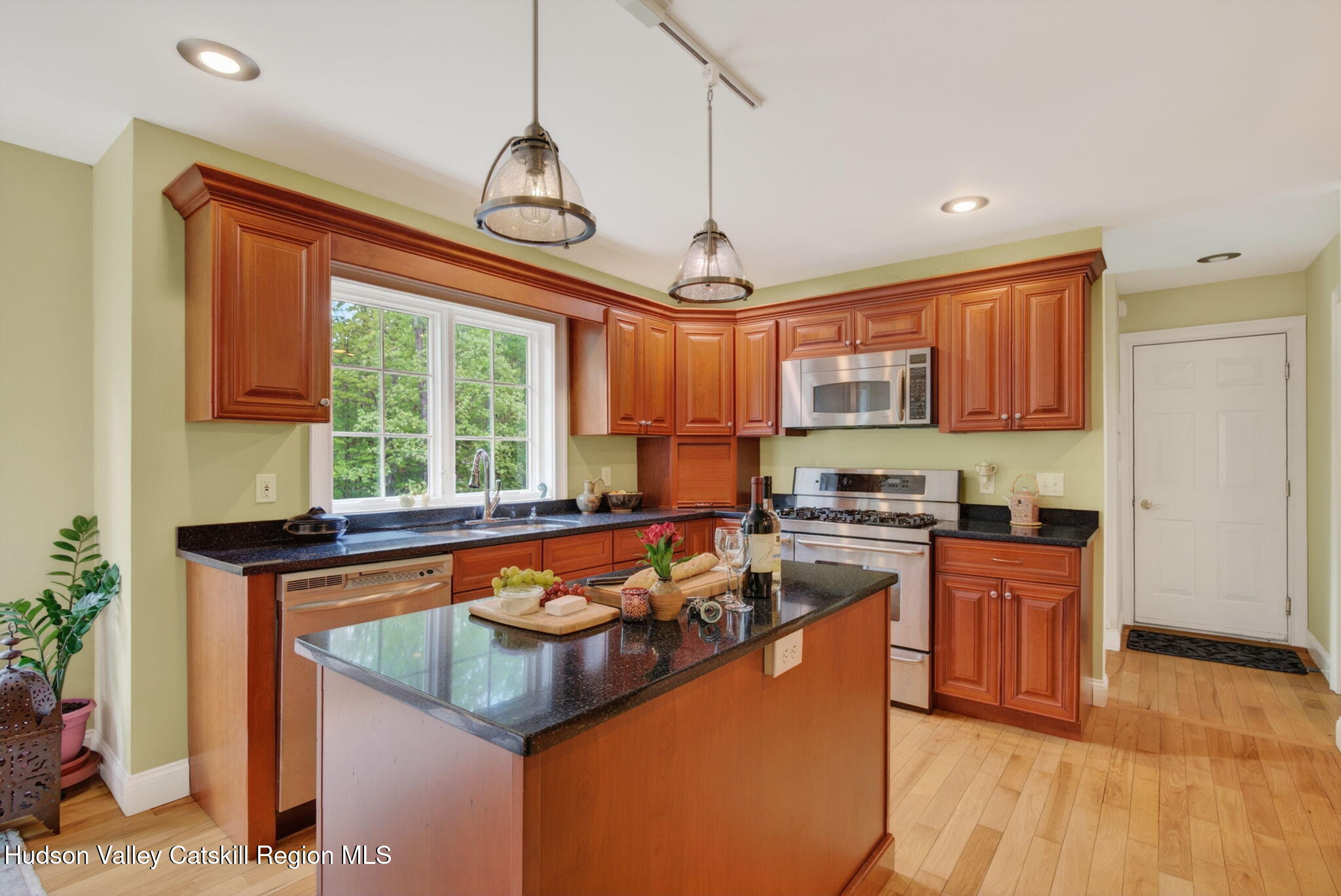 189 Bush Road Stone Ridge, NY 12484 - Photo 14 of 60 a kitchen with stainless steel appliances granite countertop a sink a stove and a wooden floors