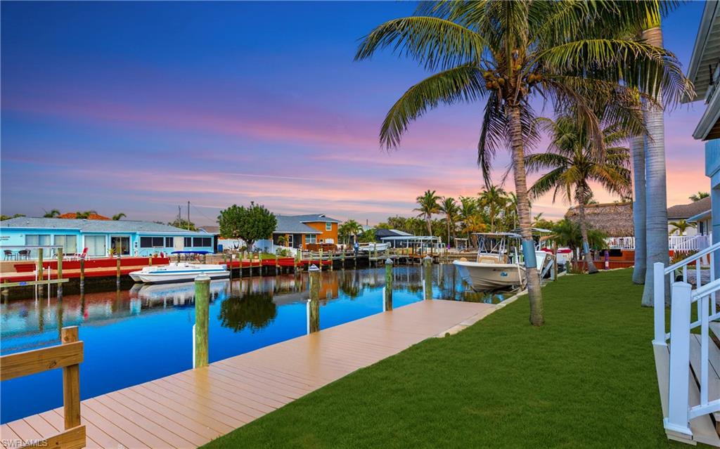 12277 Boat Shell Drive Matlacha Isles, FL 33991 - Photo 16 of 46 a view of a swimming pool with a table and chairs