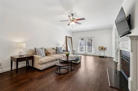 a living room with furniture fireplace and flat screen tv
