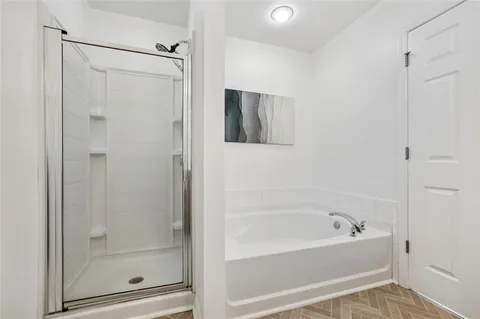 a bathroom with a bathtub and a shower