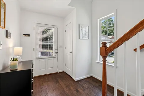 a view of an entryway with wooden floor and stairs
