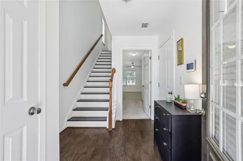 a view of an entryway with wooden floor and door