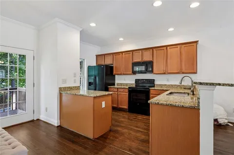 a kitchen with a sink stove top oven and refrigerator