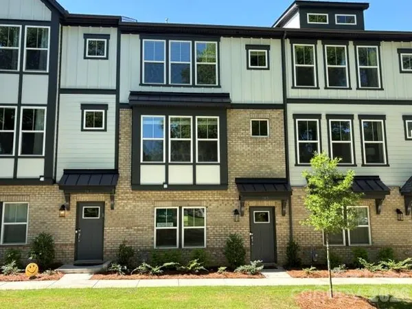 a front view of a residential apartment building with a yard