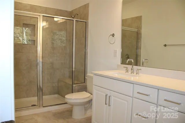 a bathroom with a shower and a sink