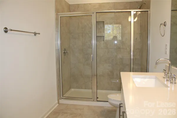 a bathroom with a shower and a sink