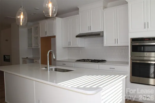 a kitchen with stainless steel appliances granite countertop a sink refrigerator and cabinets