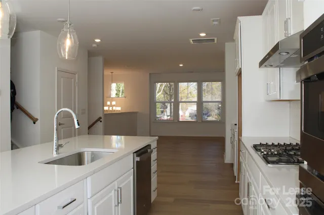 a kitchen with stainless steel appliances a sink a stove and a refrigerator