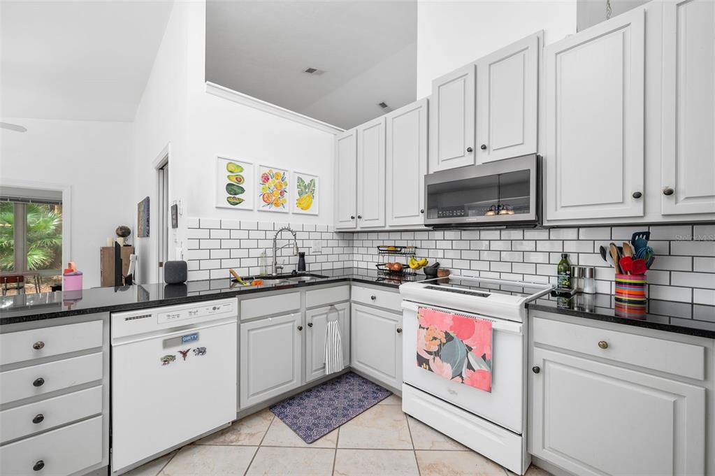 5154 Southwest 88 Terrace Gainesville, FL 32608 - Photo 12 of 29 a kitchen with cabinets appliances and a sink
