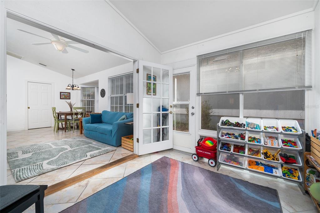 5154 Southwest 88 Terrace Gainesville, FL 32608 - Photo 17 of 29 a bedroom with furniture and a book shelf