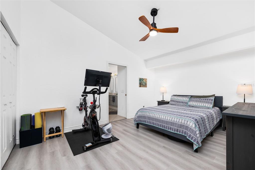 5154 Southwest 88 Terrace Gainesville, FL 32608 - Photo 23 of 29 a bedroom with a bed and a flat screen tv