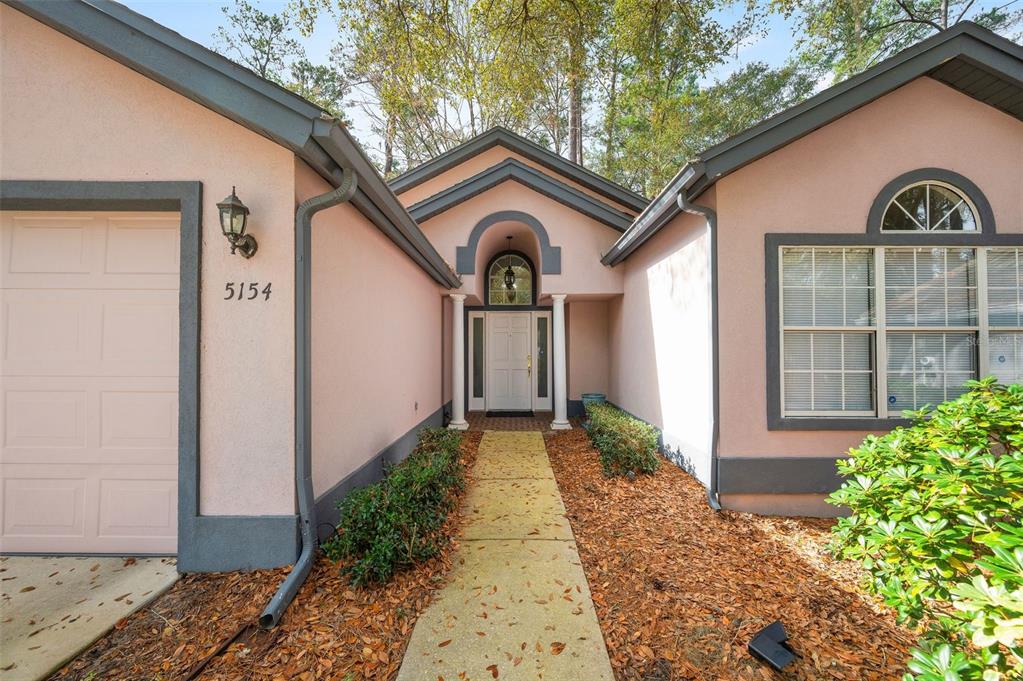 5154 Southwest 88 Terrace Gainesville, FL 32608 - Photo 4 of 29 a front view of a house with garden