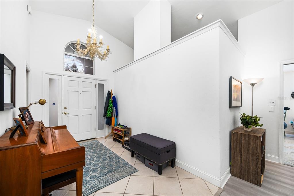 5154 Southwest 88 Terrace Gainesville, FL 32608 - Photo 5 of 29 a living room with furniture chandelier and view of kitchen