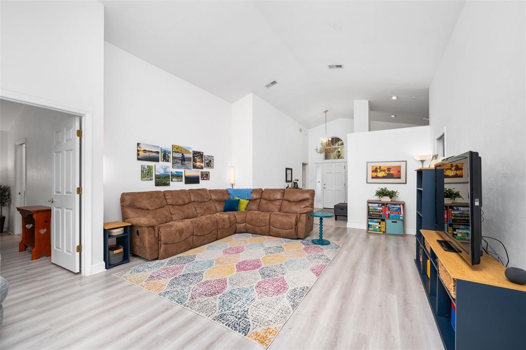 5154 Southwest 88 Terrace Gainesville, FL 32608 - Photo 8 of 29 a living room with furniture and a flat screen tv
