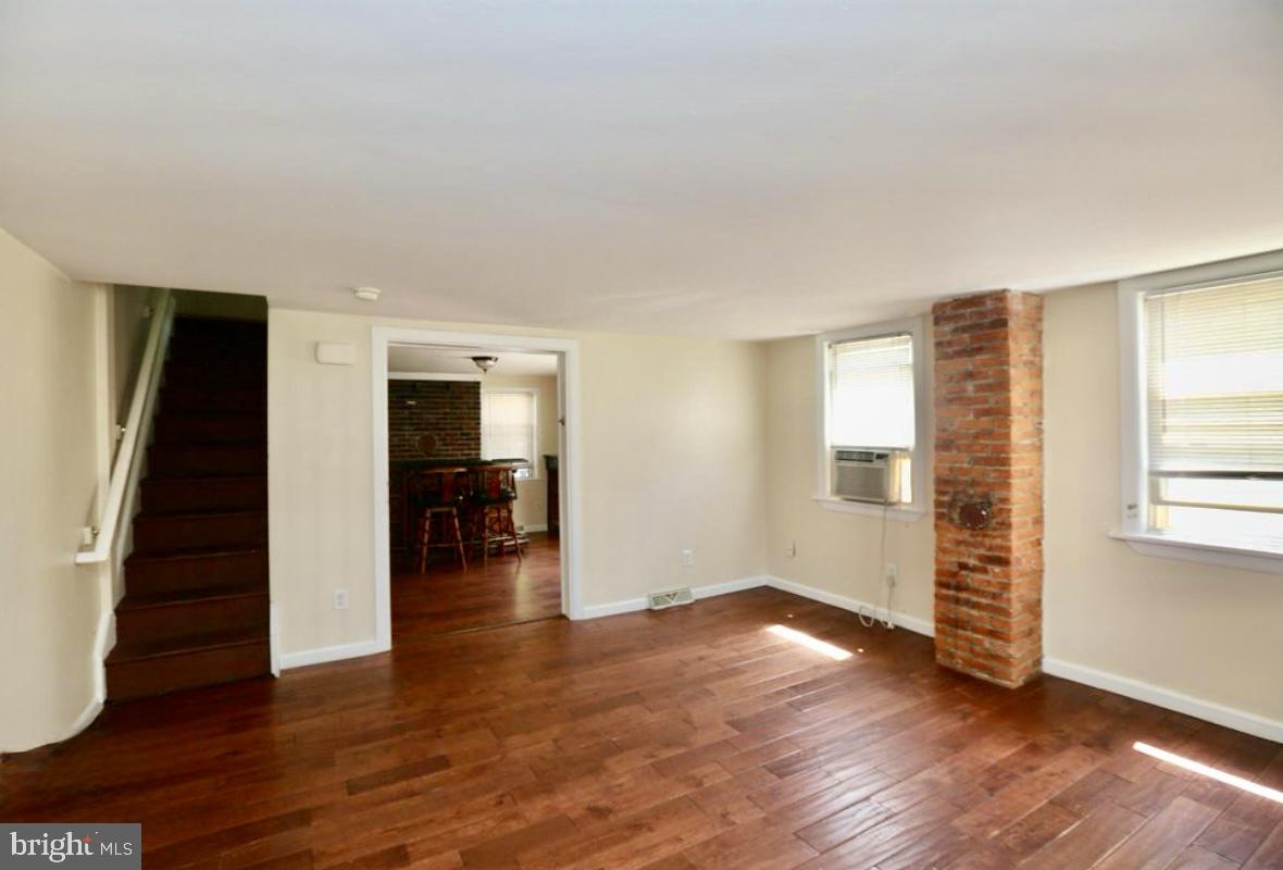 310 Ellis Street Glassboro, NJ 08028 - Photo 14 of 15 wooden floor in an empty room with a window