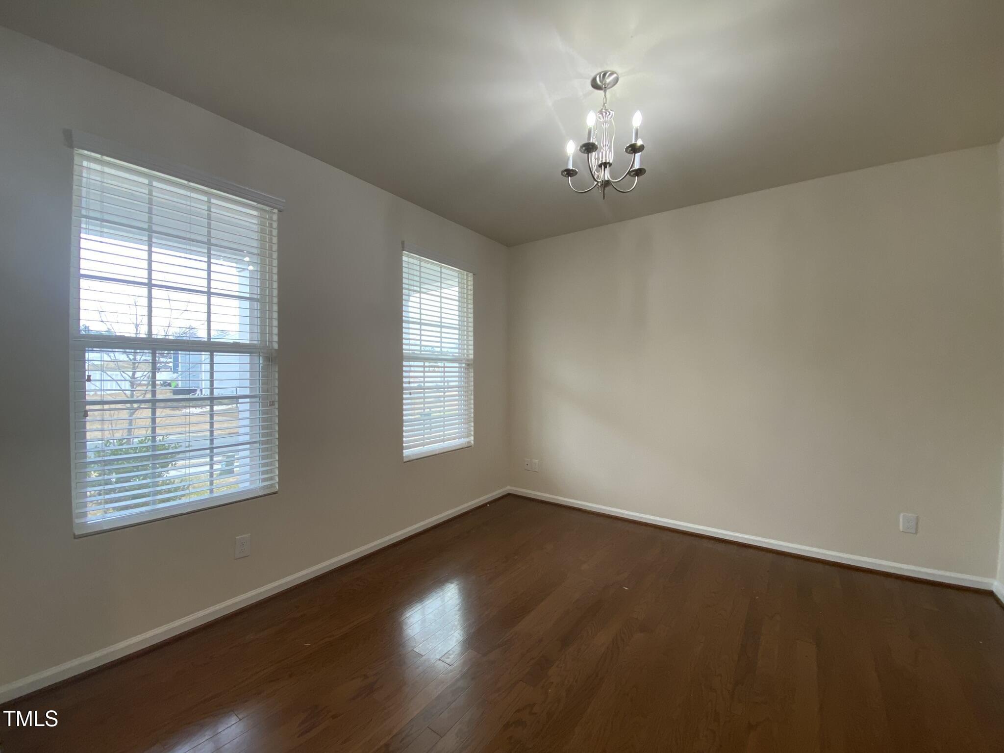 3545 Massey Ridge Court Raleigh, NC 27616 - Photo 5 of 38 wooden floor in an empty room with a window