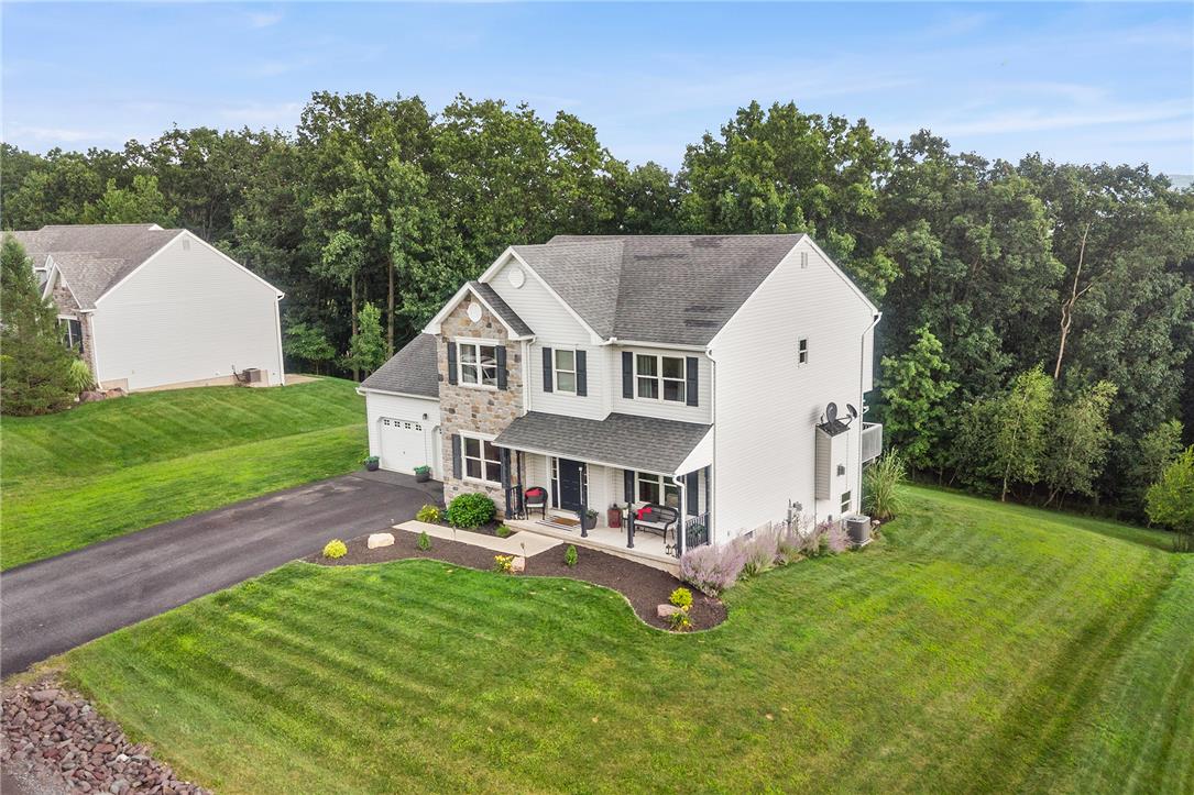 487 Long Run Road Drums, PA 18222 - Photo 10 of 35 Mature woodlands frame a two-story home featuring a stone facade and paved driveway.