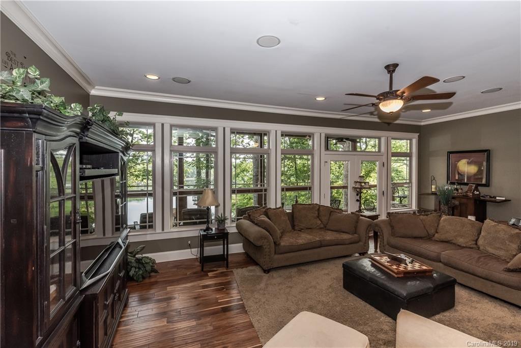 10023 Bora Bora Drive Tega Cay, SC 29708 - Photo 11 of 32 a living room with furniture a ceiling fan and a large window