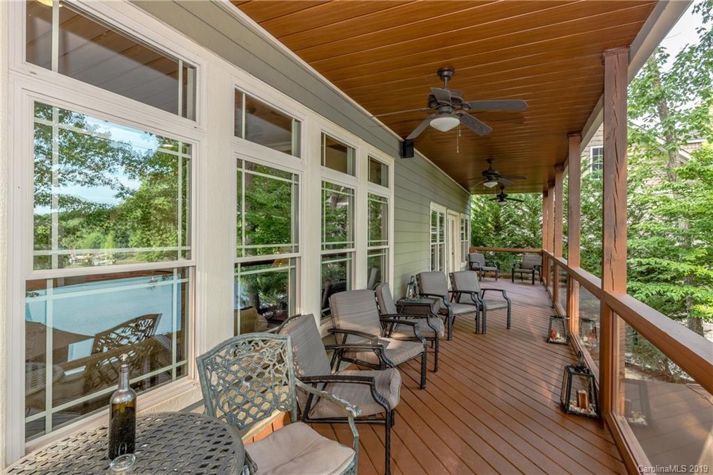 10023 Bora Bora Drive Tega Cay, SC 29708 - Photo 12 of 32 a balcony with wooden floor and furniture