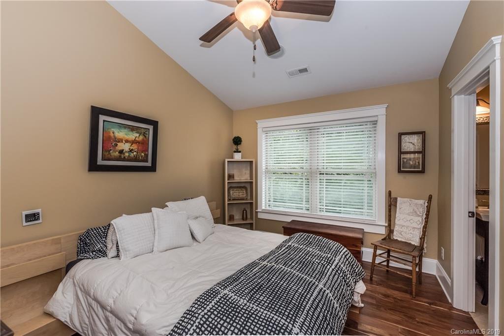 10023 Bora Bora Drive Tega Cay, SC 29708 - Photo 21 of 32 a bedroom with a large bed and a chandelier