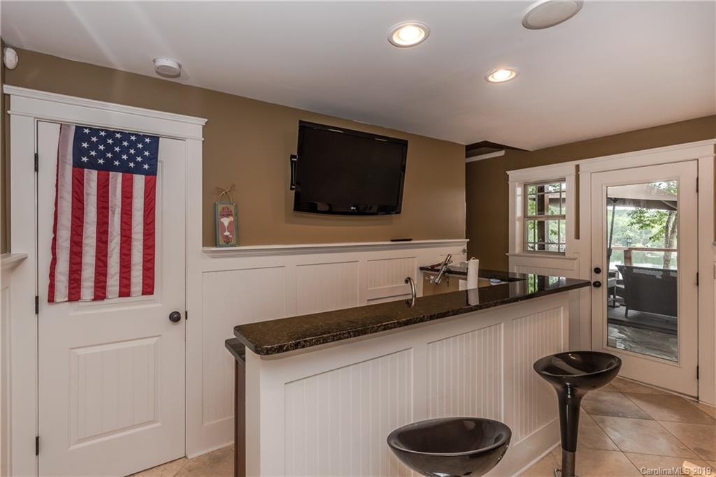 10023 Bora Bora Drive Tega Cay, SC 29708 - Photo 24 of 32 a kitchen with a sink and a stove top oven